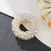 The new pearl hair band exudes a light luxury and trendy Korean style. It features a small flower-shaped female ponytail band headwear and a leather band hair tie details Picture